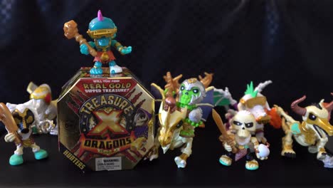 4K-video-zooming-in-on-the-Treasure-X-Dragons-Gold-toy-box-with-mini-figure-surrounding-it