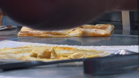 Close-Shot-of-Adding-Banana-Slices-to-Crepes-at-the-Night-Market-for-Street-Food
