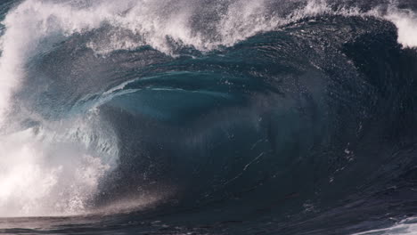 A-close-look-at-the-inside-of-a-heavy-wave-as-it-breaks-along-a-shallow-rock-shelf-in-slow-motion