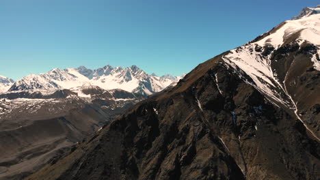 Aerial-shot-Closing-on-mountain-peak-with-the-Andes-range-on-the-background-on-a-crispy-clear-day-4K