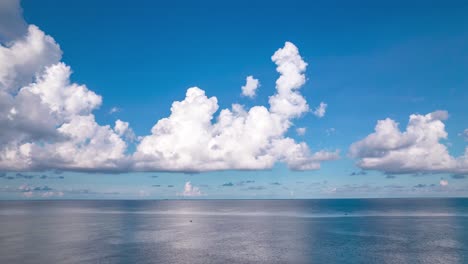 Stunning-white-clouds-scenery-hyperlapse-above-calm-open-ocean-water