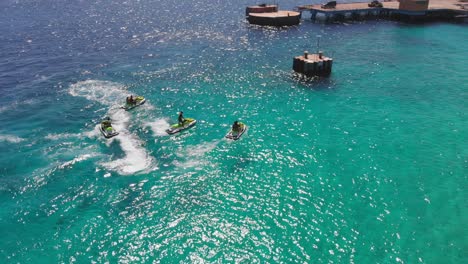 Luftaufnahmen-Einer-Jetski-Gruppe-Im-Kristallklaren-Wasser-Vor-Fort-Beekenburg-Auf-Der-Niederländischen-Karibikinsel-Curacao