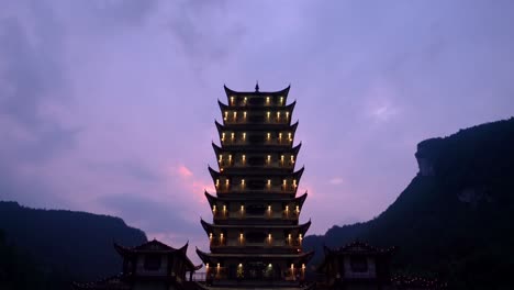 Landmark-pagoda-at-the-exit-of-Wulingyuan-entrance-to-the-Zhangjiajie-national-park-in-the-evening,-Hunan-Province