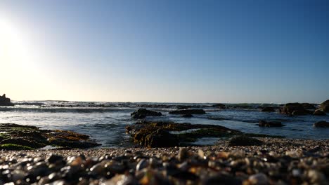 Low-angle-wide-shot-of-peaceful-Atlantic-ocean-water-on-a-sunny-blue-sky-day-in-Bantry-Bay,-South-Africa