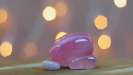 Three-pink-quartz-gemstone-with-love-healing-properties,-sliding