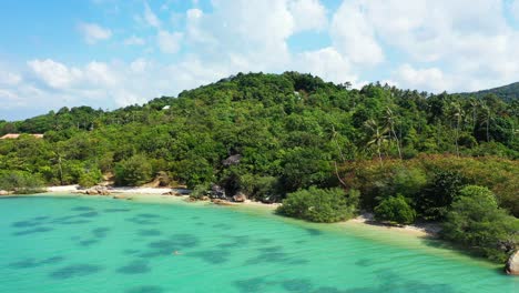 Beautiful-wild-tropical-coast-with-secluded-sandy-beach,-tropical-palm-forest-and-crystal-clear-turquoise-sea