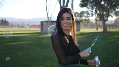 Hispanic-girl-blowing-many-dreamy-bubbles-while-smiling-and-laughing-with-happiness-as-it-pops-SLOW-MOTION