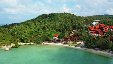 Tranquil-bay-with-calm-turquoise-lagoon-washing-sandy-exotic-beach-and-cliffs-of-tropical-island-shoreline,-vacation-resort-in-Thailand