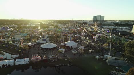 Aerial-View-of-Florida-State-Fair-During-Sunset-With-Tampa-Skyline-in-Far-Distance