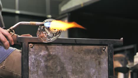 Glass-artist-torching-a-spinning-vase