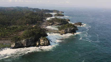 Natural-coastline-with-tropical-forest-and-crashing-waves-along-the-coastline