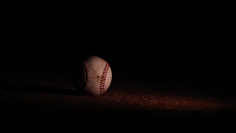 Wonderful-Baseball-Rolling-Through-Dirt-at-Night