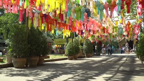 Colorful-flags-hanging-in-Phra-Singh-Temple-in-Chiang-Mai,-Thailand