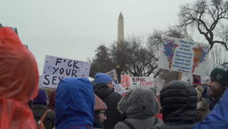 Large-group-of-protesters-with-women's-rights-signs-gathered-on-the-streets-of-Washington-DC-in-front-of-the-Washington-Monument-participating-in-the-Women's-March