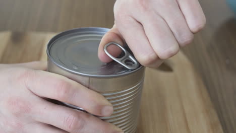 Slow-motion-as-opening-a-tin-can-with-boiled-corn