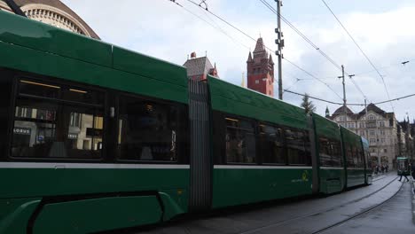 Full-shot,-Electric-tram-passing-the-train-station,-in-Basel-Switzerland