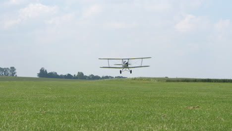 Ultra-light-bi-Plane-take-off-and-airborne-on-green-fields-in-the-countryside