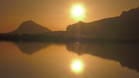 Sunrise-over-mountains-with-reflection-in-lake