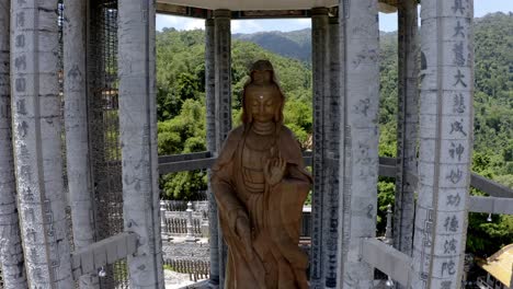 Kuan-Yin-Goddess-of-Mercy-statue-monument-inside-Kek-Lok-Si-Buddhist-temple,-Aerial-drone-orbit-reveal-shot
