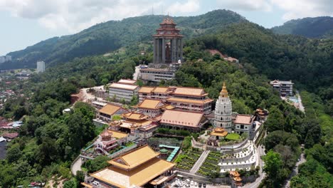 Aerial-view-of-Kek-Lok-Si-Buddhist-temple-with-pagoda,-shrines-and-Kuan-Yin-statue-visible,-Drone-close-in-reveal-shot