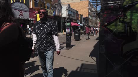 Wide-view-of-street-life-in-Toronto's-Kensington-Market-on-a-summer's-day