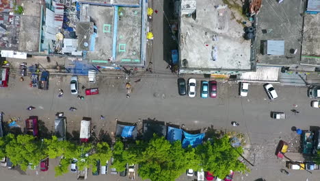 Aerial,-top-down,-drone-shot-over-streets,-cars,-mopeds-and-buildings,-in-Capotillo-district,-Santo-Domingo,-Dominican-Republic