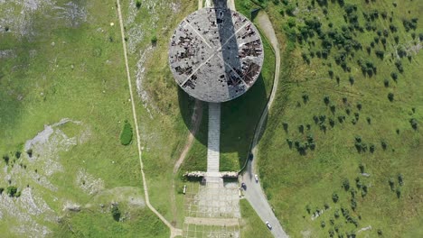 Flying-over-Buzludzha-monument,-on-top-of-the-mountain-looking-like-a-flying-saucer-in-Bulgaria