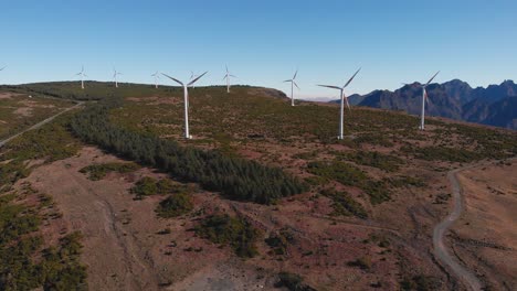 Wide-panoramic-shot-over-highland-field-wind-turbine-energy-farm,-Madeira-Island
