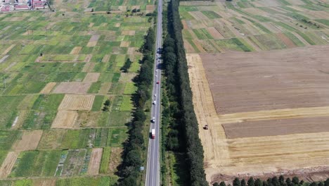 Aerial-View-of-Road-With-Semi-Trucks-in-Rural-Farmland-in-Ukraine