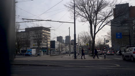 A-reveal-shot-of-Rotterdam-Eendrachtsplein-with-people-and-cars-travelling-past
