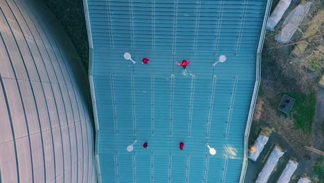 Aerial-top-down-shot-of-dancers-in-red-on-staircase