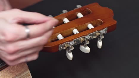 Guitar-maker-put-new-strings-on-guitar