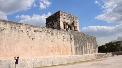 Tourist-taking-a-picture-of-the-Great-Ball-Court-at-Chichen-Itza-archaeological-site