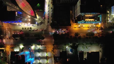 Traffic-in-Santo-Domingo-at-night,-take-aerial-with-drone