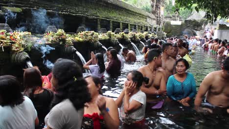 Group-of-Asian-People-Taking-Ritual-Bath-in-Holy-Spring-Temple