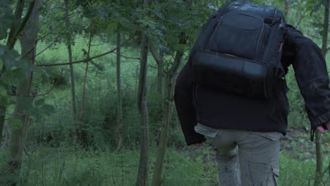 Young-refugee-enters-forest-with-belongings-in-backpack