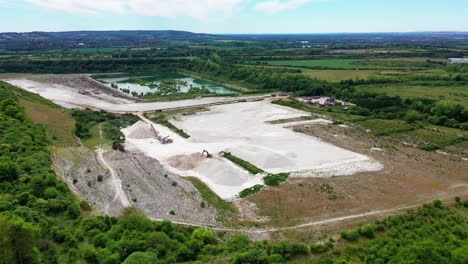 Aerial-landscape-of-a-chalk-quarry-in-the-countryside,-on-a-bright-sunny-day