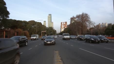 Vehicles-circulating-on-big-avenue-towards-camera-in-Buenos-Aires,-Argentina