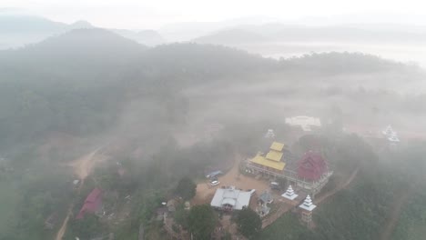 Aerial-Footage-Of-Wat-Su-Tong-Pae,-Famous-Temple-In-Mae-Hong-Son,-Thailand-in-Foggy-Weather