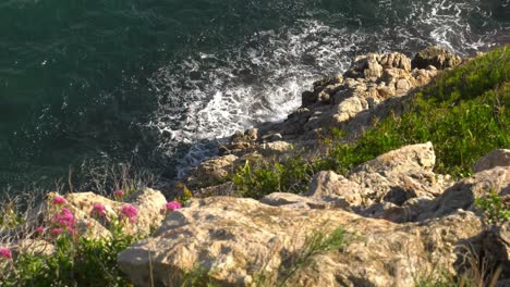 Ocean-waves-breaking-on-sea-cliffs,-mediterranean-coast-of-Spain