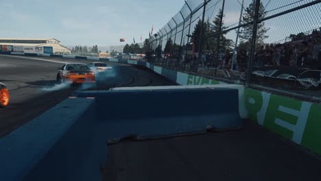 Group-of-Cars-Drifting-into-the-Corner-of-a-Race-Track-at-Drift-Con