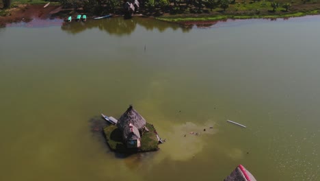 4K-daytime-aerial-drone-view-looking-at-the-beautiful-house-over-the-water-at-Laguna-de-los-Milagros-,-Tingo-Maria---Gate-to-the-Amazon-in-Peru