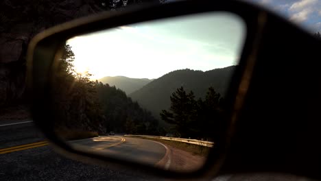 View-of-mountain-road-on-the-side-mirror-of-a-car