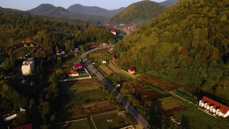 Aerial-view-overlooking-the-Shayan-town,-during-golden-hour,-in-the-Carpathian-Mountains,-Ukraine---rising,-drone-shot
