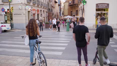 People-Waiting-on-Crosswalk-on-Busy-Streets-of-Malaga,-Spain