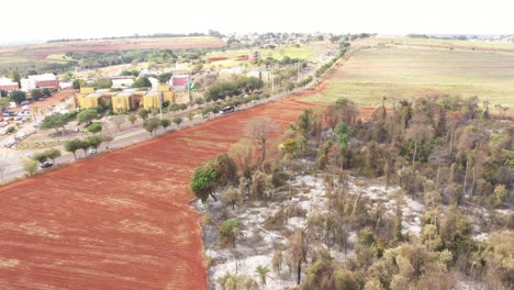 City-and-burnt-vegetation-in-Campinas,-Sao-Paulo,-drone-shot
