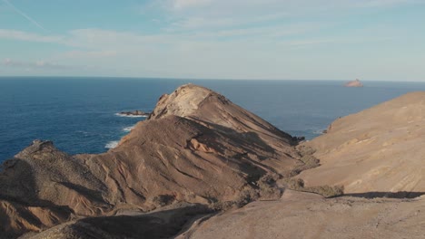 Drone-pov-flying-over-rocky-promontory-of-Porto-Santo-island