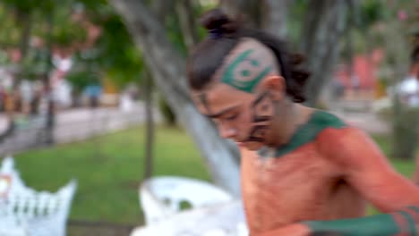 Extreme-closeup-of-a-Mayan-or-Aztec-dancer-playing-a-conch-shell-during-a-sacred-dance-performance