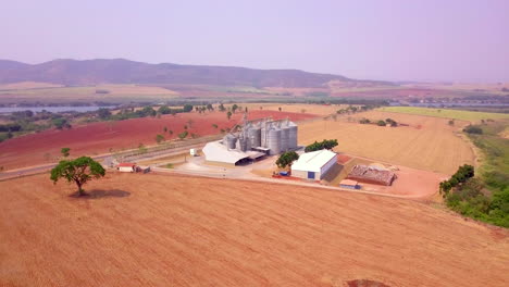 Grain-storage-silos-and-stunning-scenery,-orbiting-aerial-shot
