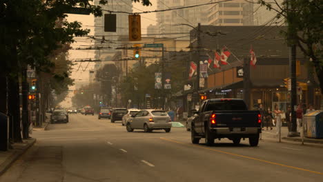 Wildfires-Causing-Smog-In-The-Streets-Of-Robson-And-Burrard-Downtown-In-Vancouver,-Canada-With-Moderate-Traffic-Scene-During-The-Day---Wide-Shot